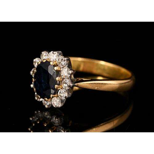 A bespoke 18K yellow & white gold , with oval-cut sapphire ,surround with Diamonds  -halo ring