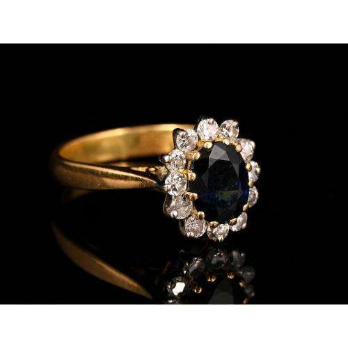 A bespoke 18K yellow & white gold , with oval-cut sapphire ,surround with Diamonds  -halo ring