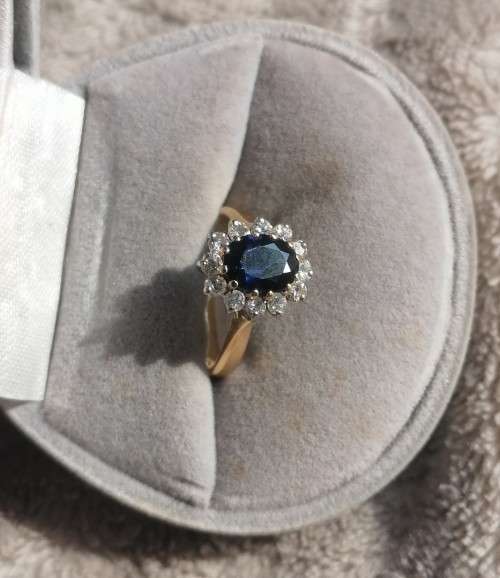 A bespoke 18K yellow & white gold , with oval-cut sapphire ,surround with Diamonds  -halo ring