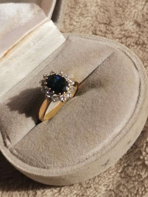 A bespoke 18K yellow & white gold , with oval-cut sapphire ,surround with Diamonds  -halo ring