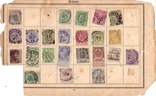 A collection of very old Belgium stamps on an album page