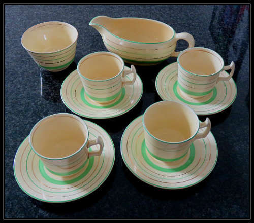 Clarice Cliff - Four Coffee cups and saucers - one sugar bowl - one sauce bowl