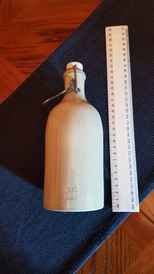 Collectable Stone Bottle (empty) with flip-top stopper and brace.  No label. Colour: Grey/white.