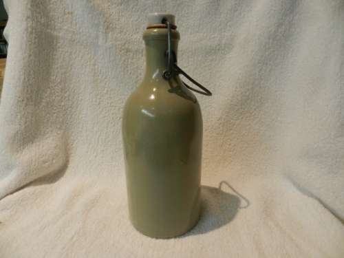 Collectable Stone Bottle (empty) with flip-top stopper and brace.  No label. Colour: Grey/white.