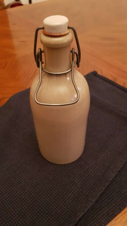 Collectable Stone Bottle (empty) with flip-top stopper and brace.  No label. Colour: Grey/white.