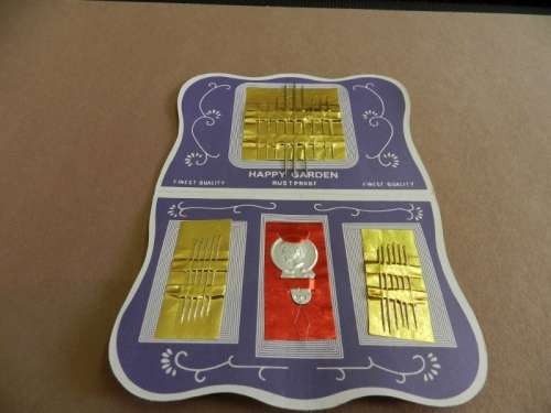 Vintage collectable booklet of 21 assorted silver eye needles and threader.  Happy Garden booklet
