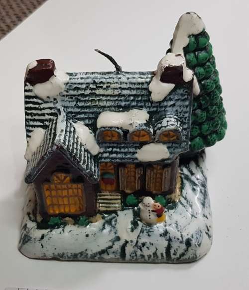 Vintage Christmas decoration. Christmas themed large candle depicting house in the snow.