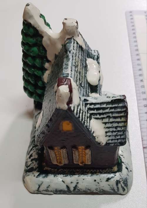 Vintage Christmas decoration. Christmas themed large candle depicting house in the snow.
