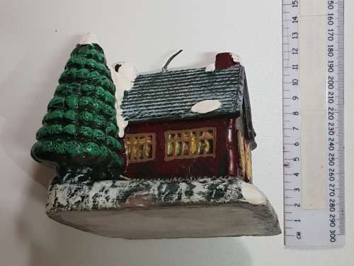 Vintage Christmas decoration. Christmas themed large candle depicting house in the snow.