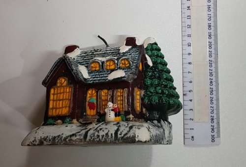 Vintage Christmas decoration. Christmas themed large candle depicting house in the snow.