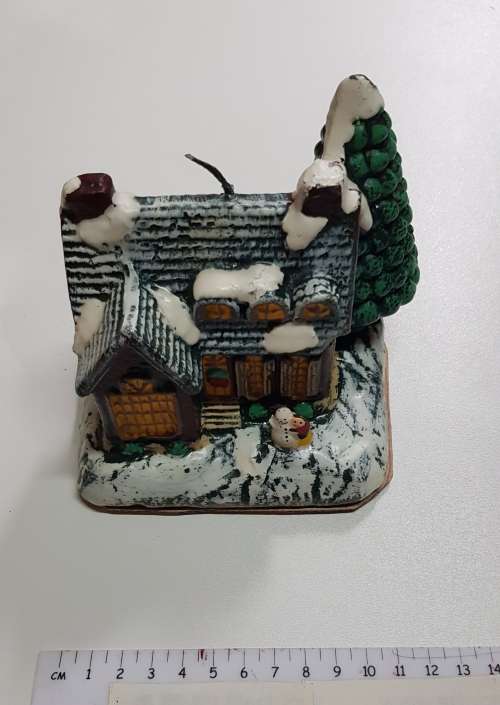 Vintage Christmas decoration. Christmas themed large candle depicting house in the snow.