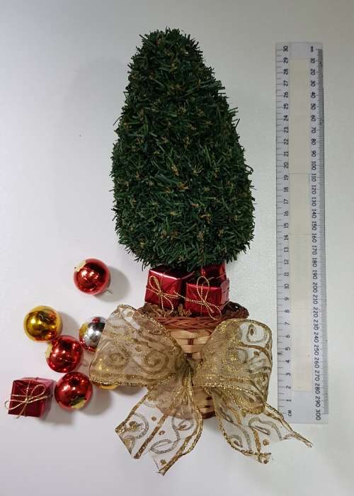 Vintage Christmas decoration. Small Christmas tree in basket with gifts under the tree