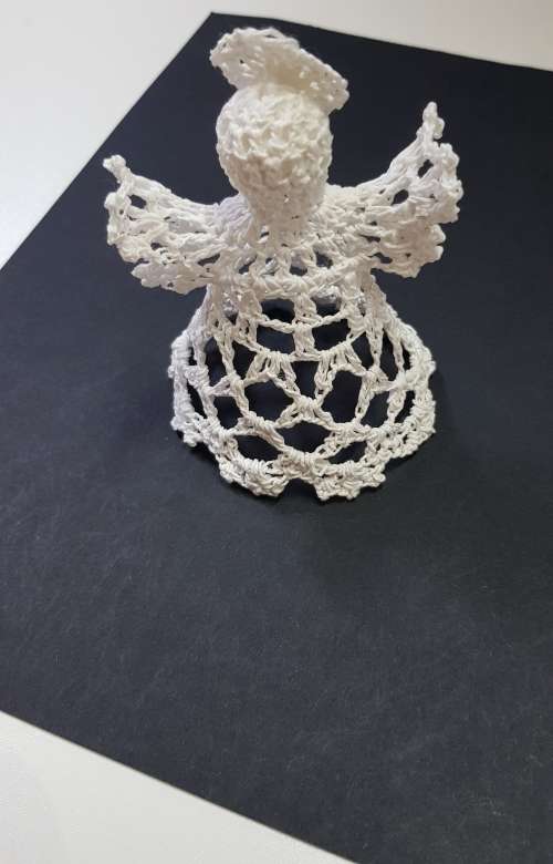 Christmas decoration. Small Christmas tree angel in white crochet thread