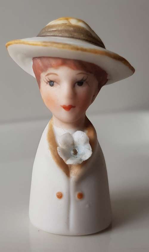 A Vintage collectors thimble. A Bisque Porcelain Thimble - Lady Wearing Hat.