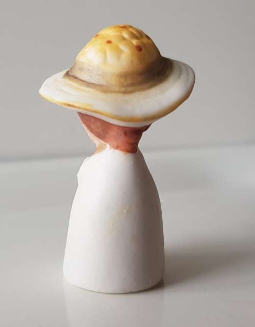 A Vintage collectors thimble. A Bisque Porcelain Thimble - Lady Wearing Hat.