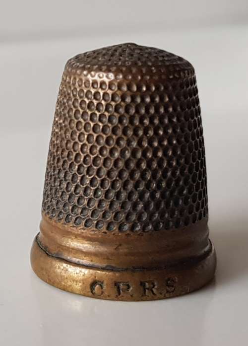 A Vintage collectors brass metal thimble. The Brass Thimble is marked C.P.R.S. on the rim.