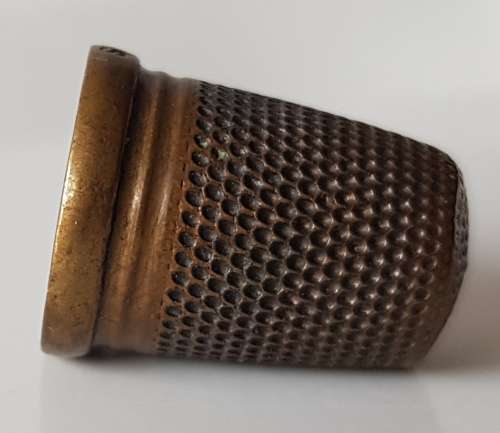 A Vintage collectors brass metal thimble. The Brass Thimble is marked C.P.R.S. on the rim.