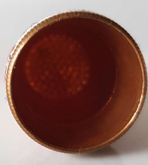A Vintage collectors metal thimble. Thimble has small embroidered floral band