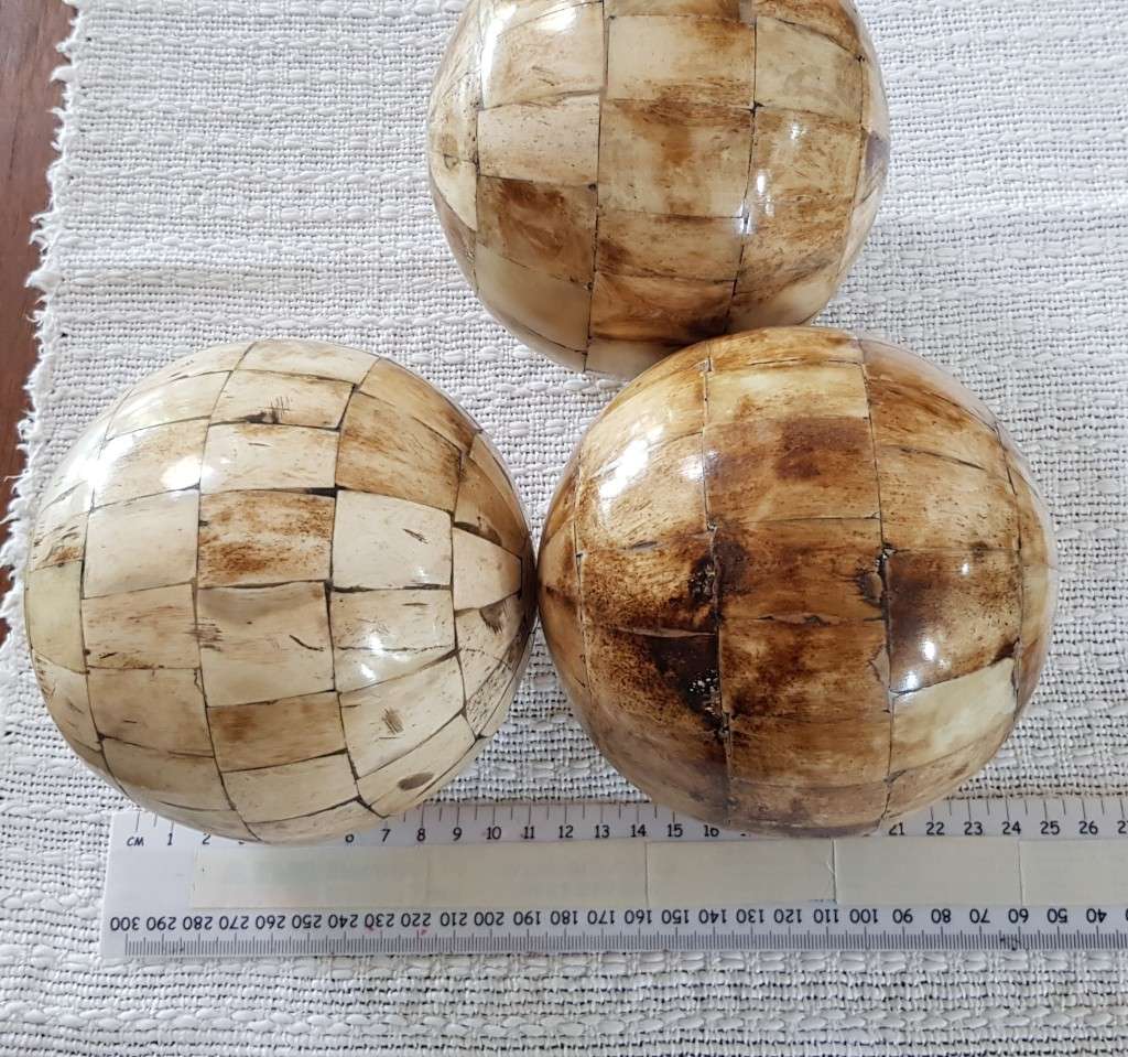 African curios:  Set of three large Decorative balls with inlaid cow horn mosaic around the balls.