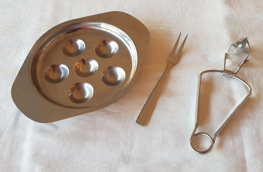 Stainless Steel Escargot dish with tongs and fork.