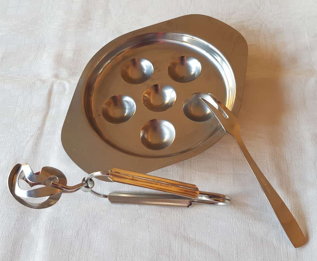 Stainless Steel Escargot dish with tongs and fork.