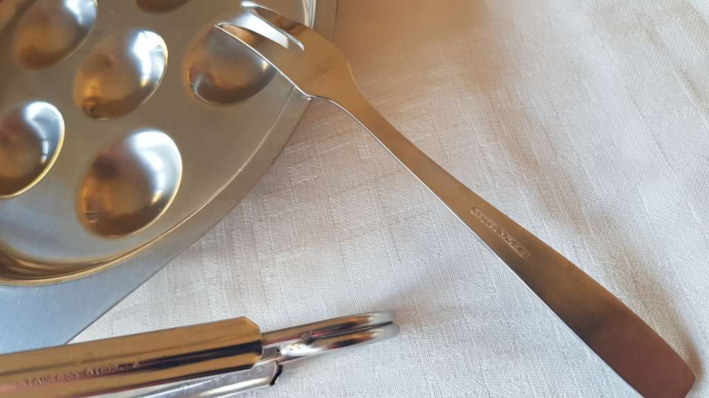 Stainless Steel Escargot dish with tongs and fork.