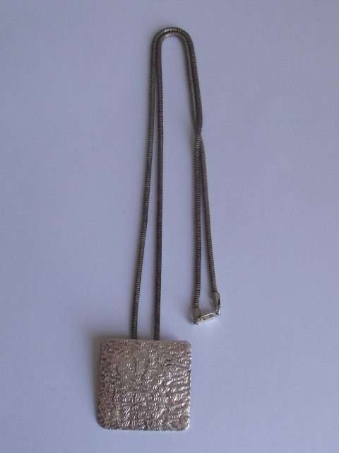 BEATEN DESIGN STERLING SILVER PENDANT ON A SNAKE STYLE STERLING SILVER CHAIN