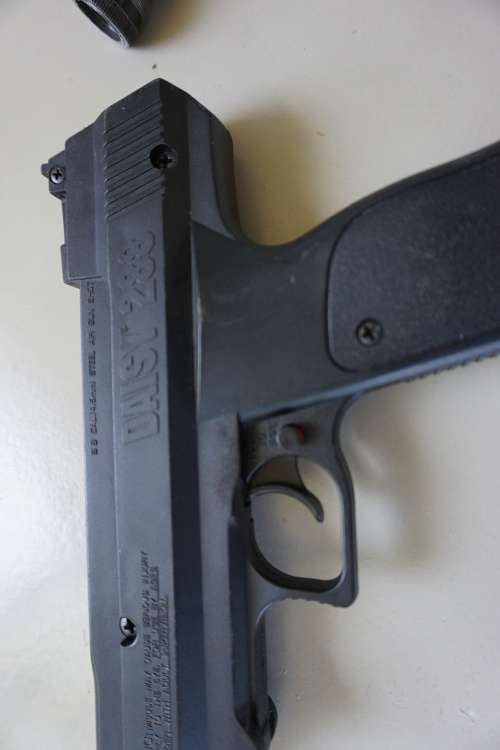 Vintage Daisy air pistol with toy rifle scope?