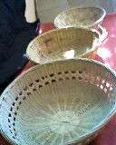 3 CANE BASKETS/BOWLS. FITS INTO EACH OTHER FOR STORAGE WHEN EMPTY. DAMAGE ON MIDDLE BASKET.