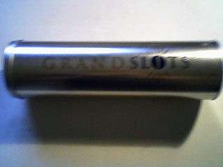 GRAND SLOTS TIN WITH LID. 9cm DIAMETER 31 cm HIGH.