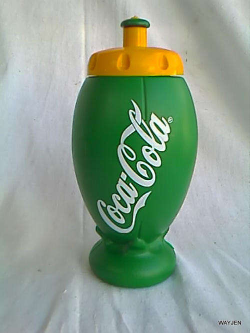 COCA COLA ON A RUGBY BALL SHAPED PLASTIC WATER/JUICE DRINKS BOTTLE.