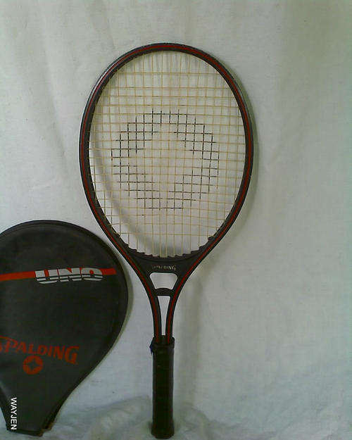 SPALDING UNO TENNIS RACQUET IN BAG. GOOD CONDITION. STRINGS TIGHT.