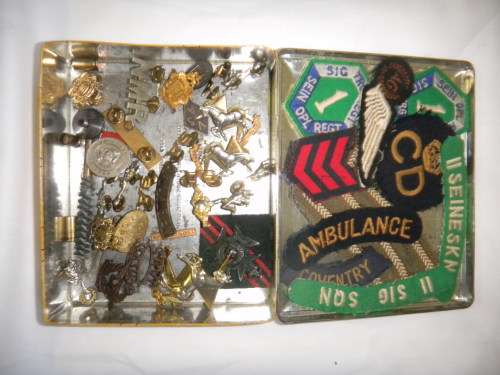 Assorted Military Badges and Insignia in collectible tin