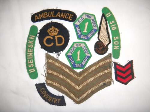 Assorted Military Badges and Insignia in collectible tin