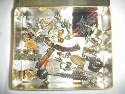 Assorted Military Badges and Insignia in collectible tin