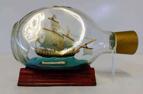 `SANTA MARIA` SHIP IN A BOTTLE FROM THE QUORN RANGE OF MODEL SHIPS on a wooden stand.
