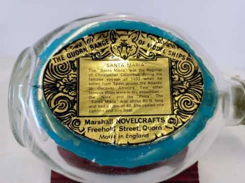 `SANTA MARIA` SHIP IN A BOTTLE FROM THE QUORN RANGE OF MODEL SHIPS on a wooden stand.