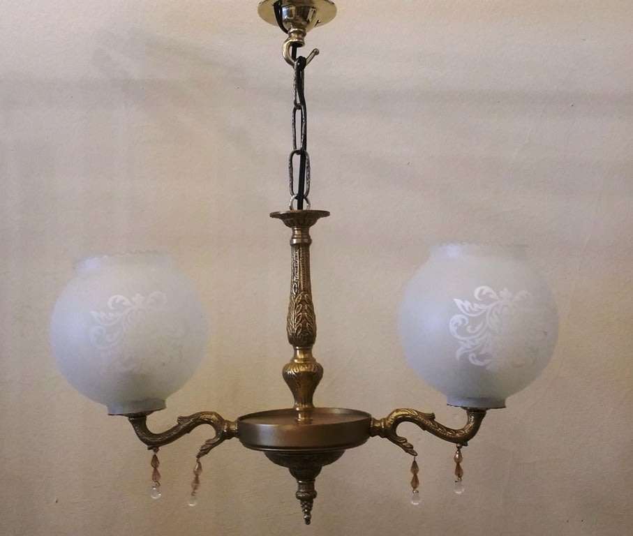 BRASS AND GILT TONE TWO ARM CHANDELIER WITH FROSTED GLASS SHADES