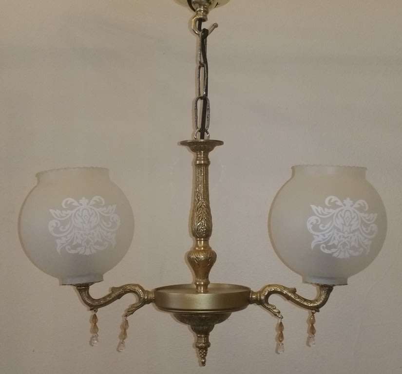 BRASS AND GILT TONE TWO ARM CHANDELIER WITH FROSTED GLASS SHADES