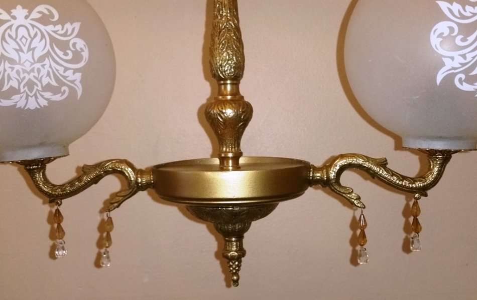 BRASS AND GILT TONE TWO ARM CHANDELIER WITH FROSTED GLASS SHADES
