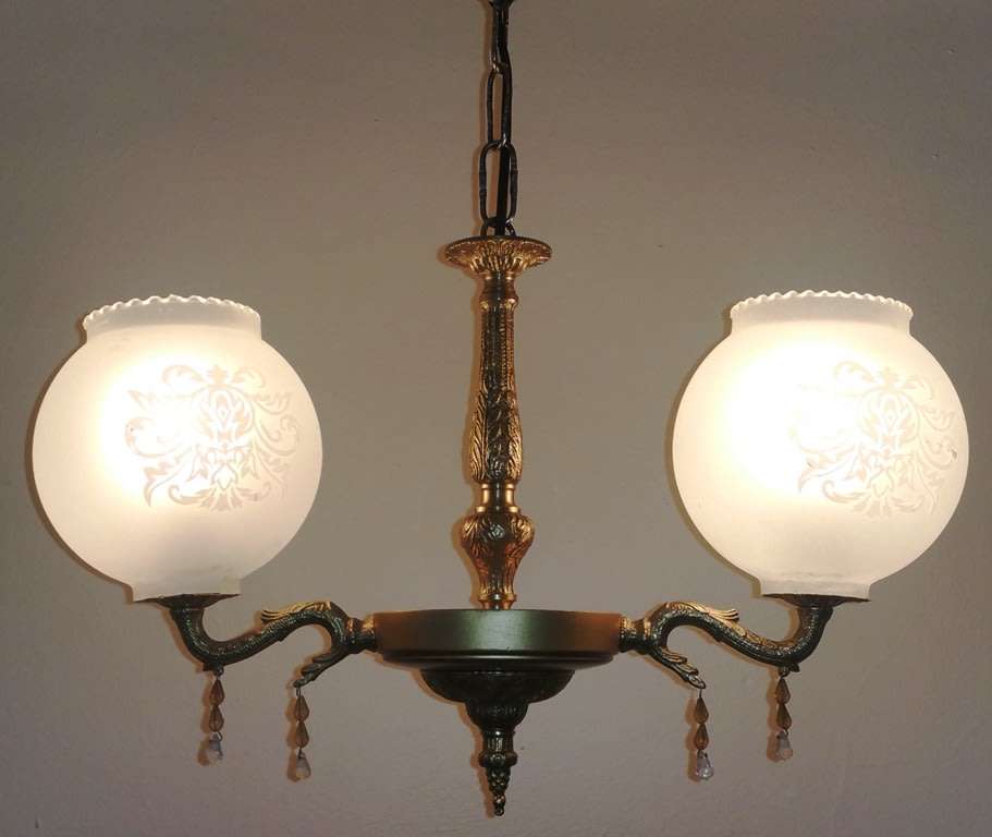 BRASS AND GILT TONE TWO ARM CHANDELIER WITH FROSTED GLASS SHADES