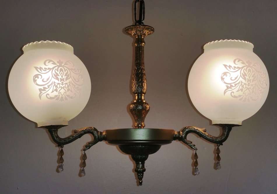 BRASS AND GILT TONE TWO ARM CHANDELIER WITH FROSTED GLASS SHADES