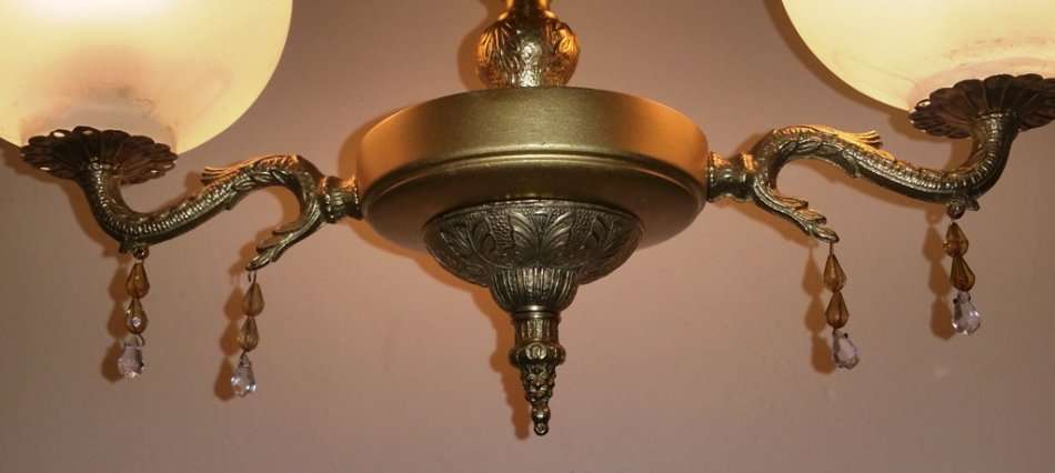 BRASS AND GILT TONE TWO ARM CHANDELIER WITH FROSTED GLASS SHADES