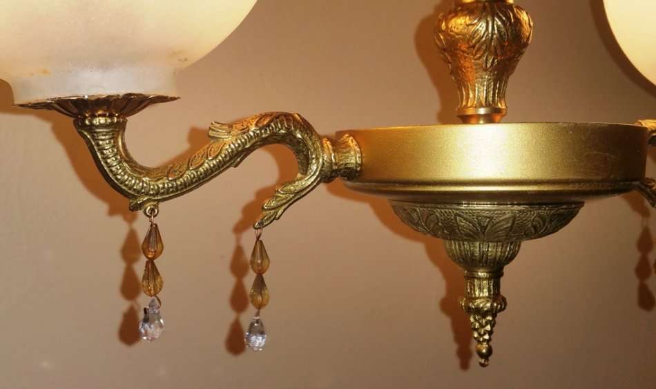 BRASS AND GILT TONE TWO ARM CHANDELIER WITH FROSTED GLASS SHADES