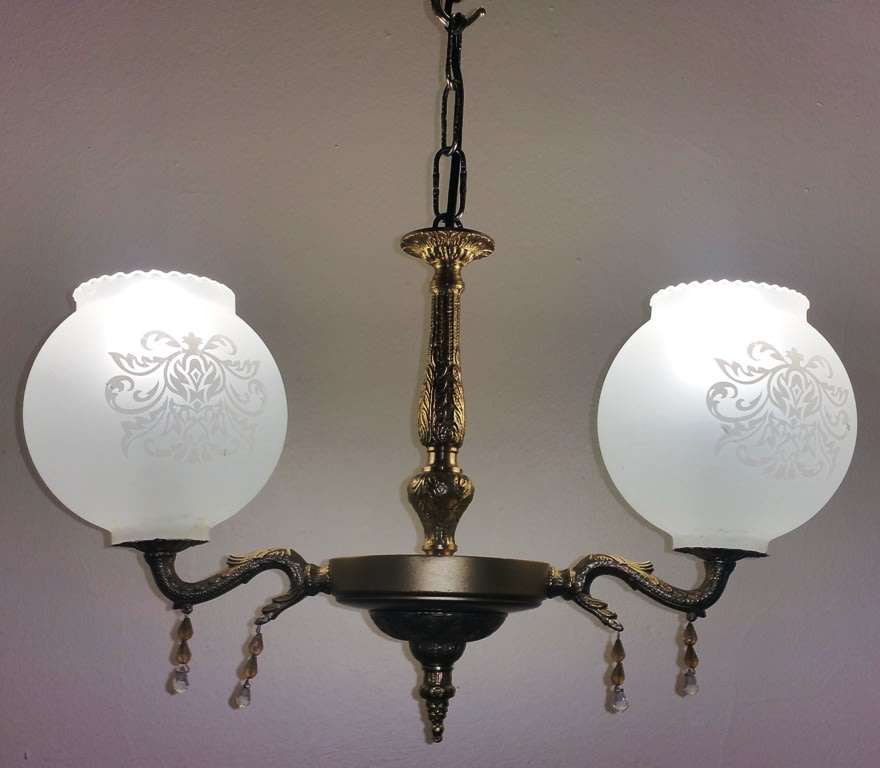BRASS AND GILT TONE TWO ARM CHANDELIER WITH FROSTED GLASS SHADES