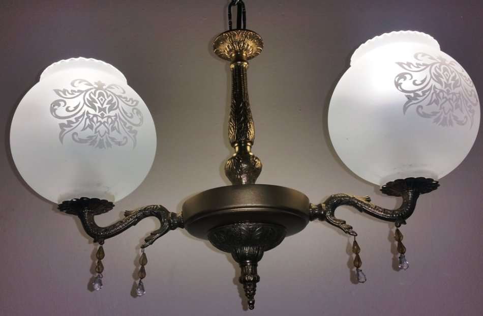 BRASS AND GILT TONE TWO ARM CHANDELIER WITH FROSTED GLASS SHADES