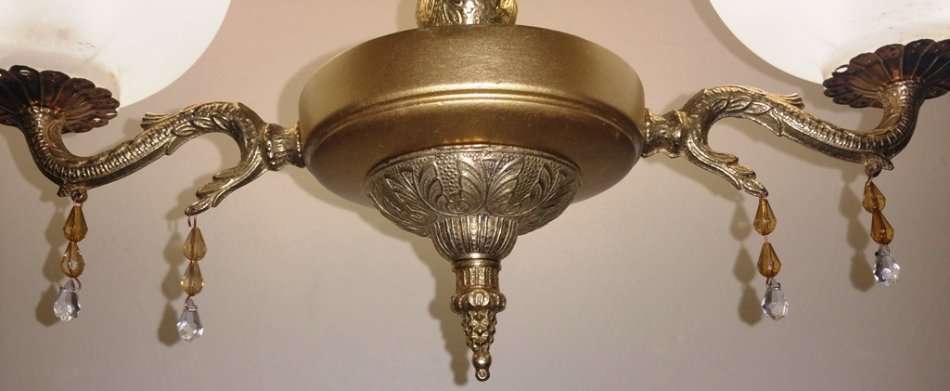 BRASS AND GILT TONE TWO ARM CHANDELIER WITH FROSTED GLASS SHADES
