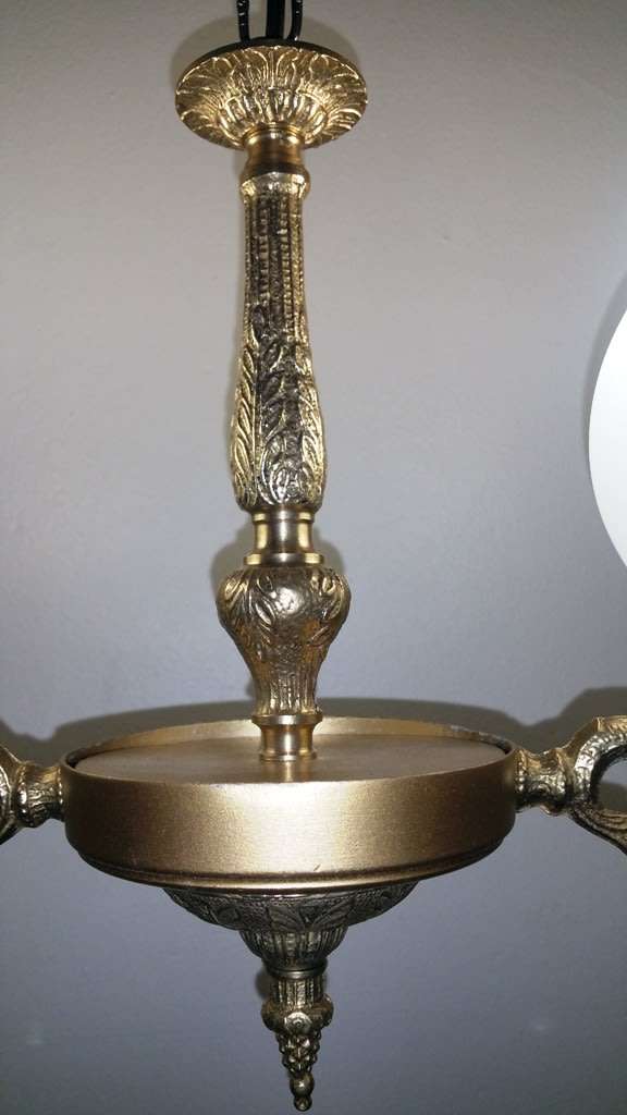 BRASS AND GILT TONE TWO ARM CHANDELIER WITH FROSTED GLASS SHADES