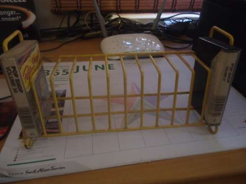 On offer YELLOW 12 CASSETTE TAPE STAND (I OF 2 AVAILABLE)
