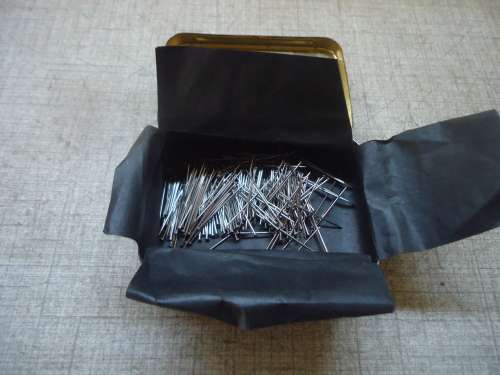 TIN OF BRASS WRITING PEN NIBS & A TIN LION OF FINEST QUALITY STEEL PINS